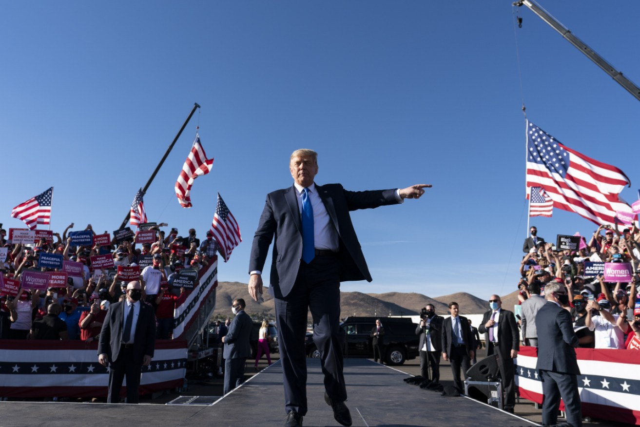 Mr Trump at a campaign rally at Carson City Airport on Monday morning (Australian time).
