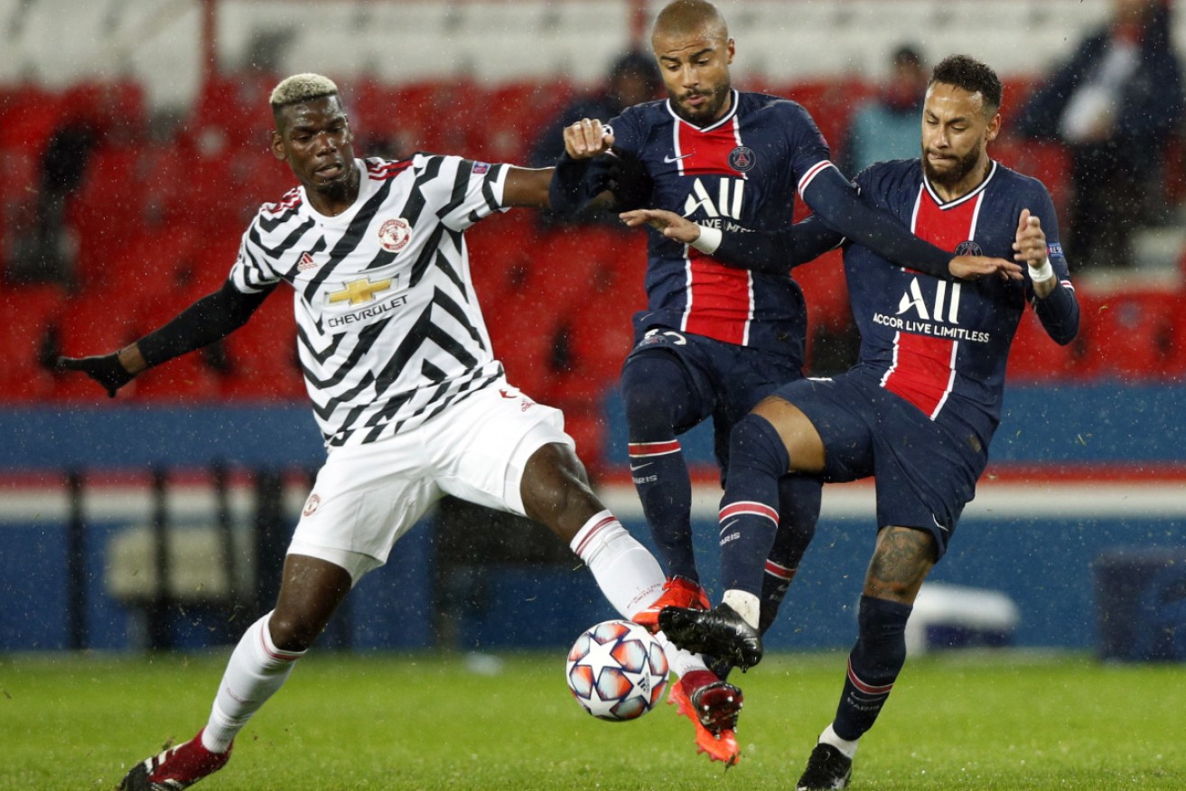 From left: Manchester United's Paul Pogba takes on Paris Saint Germain's Rafinha and Neymar.