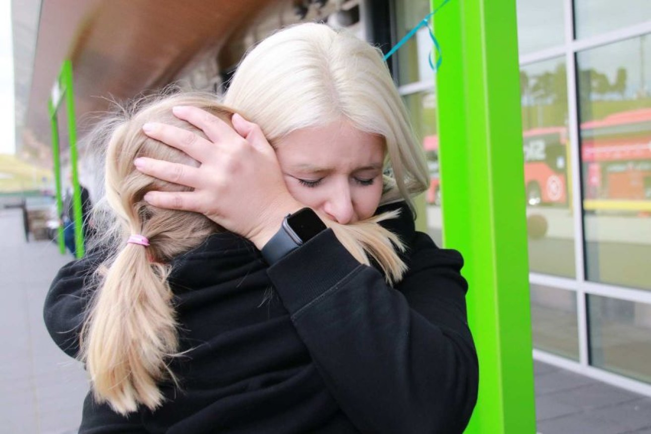 Emily Myors hugs niece Sadie at Hobart Airport.