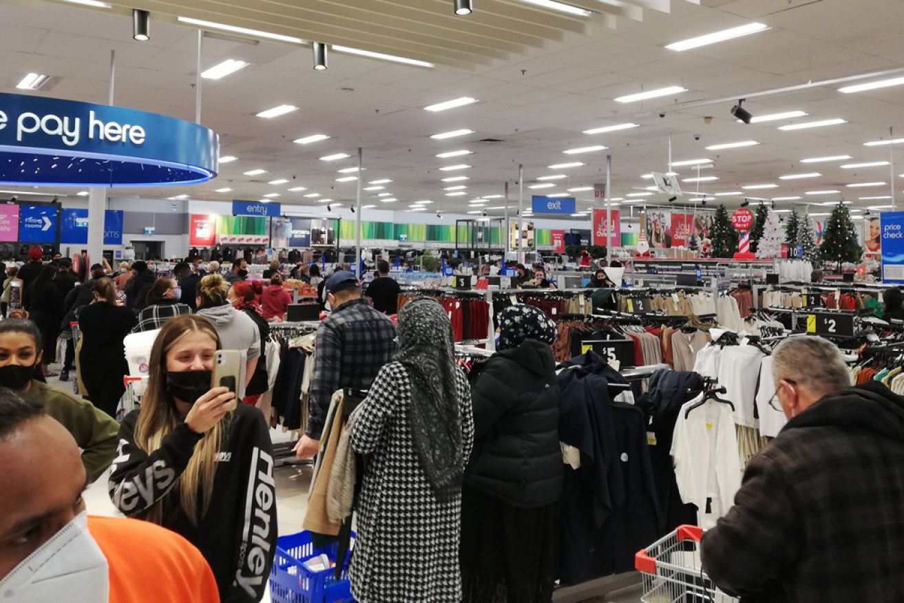Deprived shoppers get their retail fix at a Kmart in Melbourne's north very early on Wednesday morning.