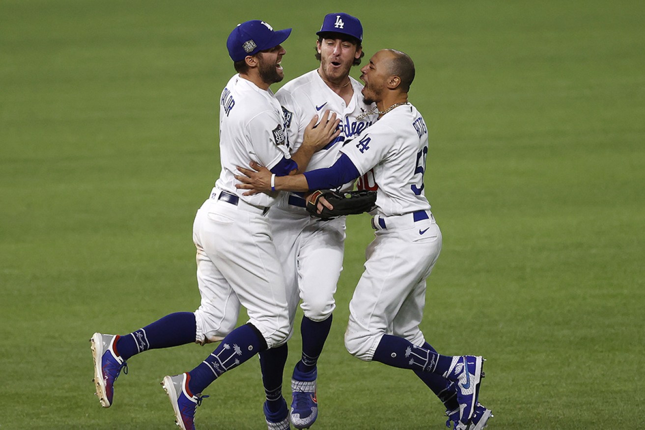 LA Dodgers trio Chris Taylor, Cody Bellinger and Mookie Betts celebrate after the Game 6 win in Arlington, Texas.