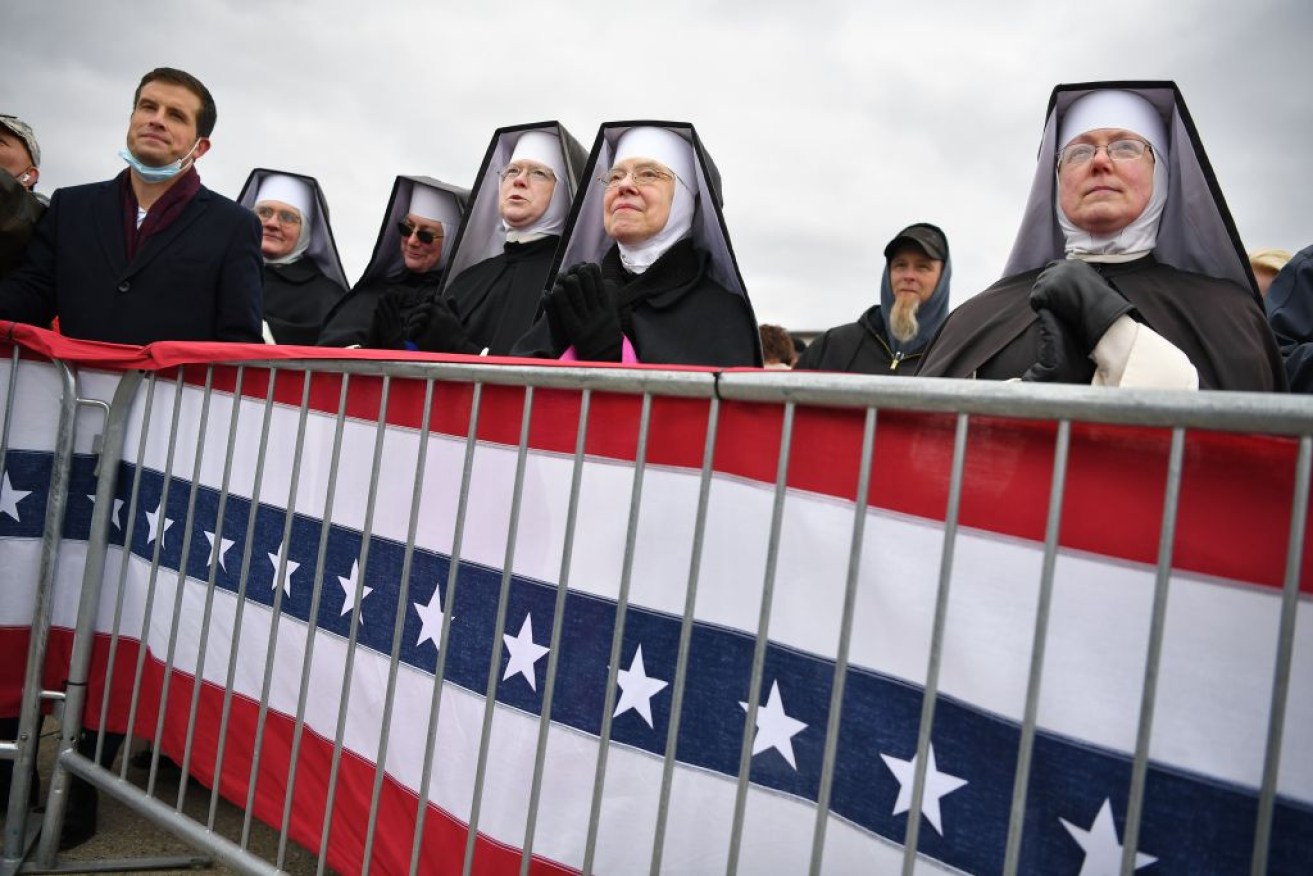 Dominican Sister of Heartland, Michigan, watch as US President Donald Trump arrives to speak at a "Make America Great Again" rally at Oakland County International Airport.