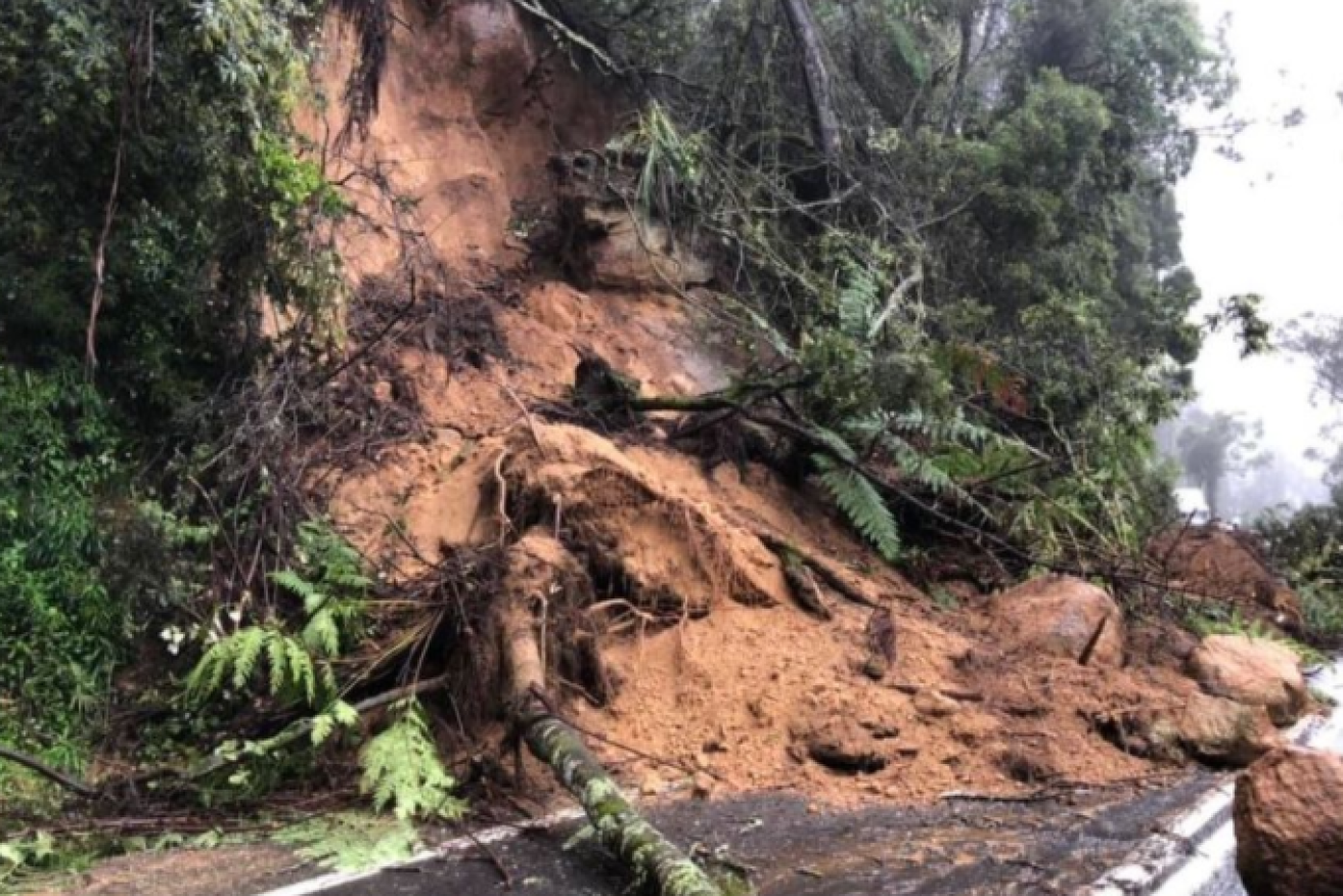 A rain-sodden landslide blocks the Snowy Mountains Highway.