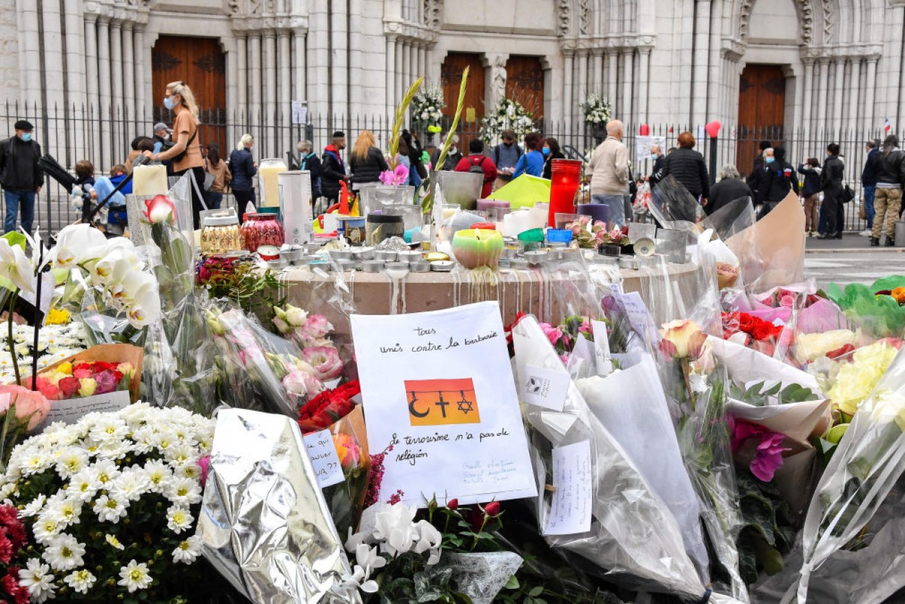 Floral tributes are laid to the victims outside Notre-Dame de l'Assomption Basilica in Nice.

