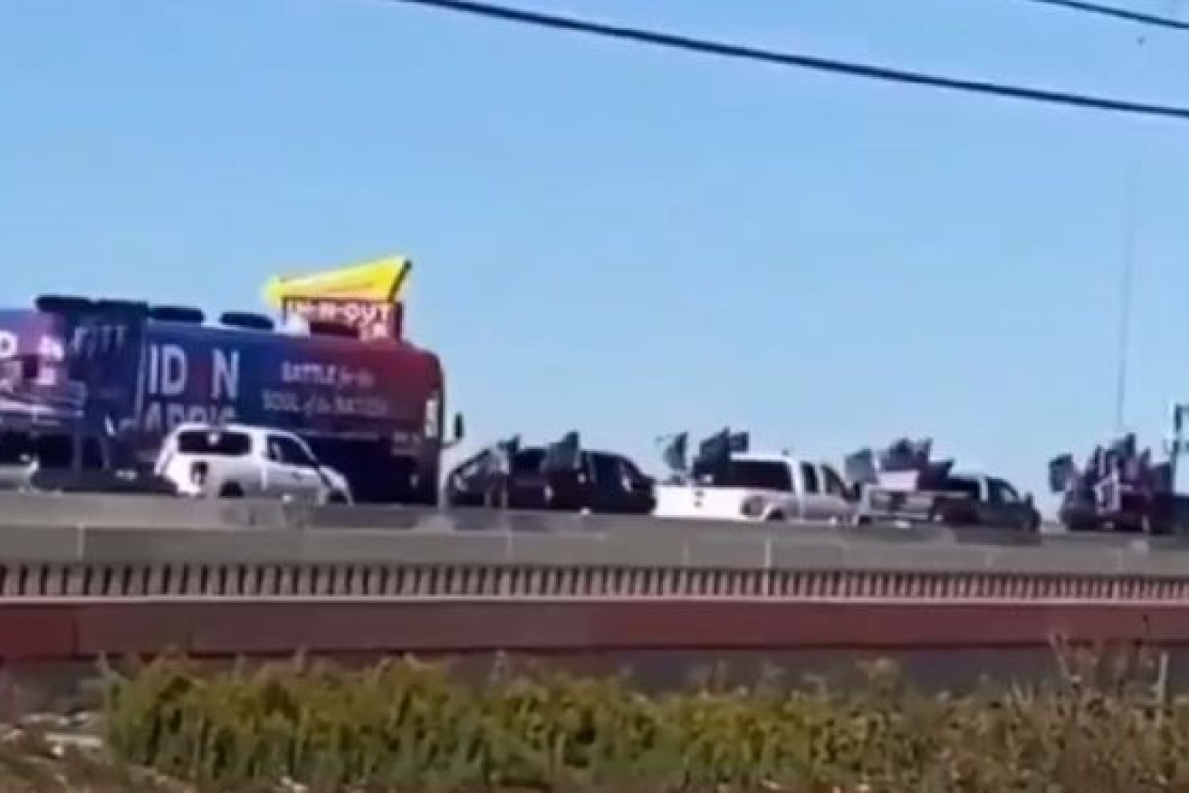 Trump supporters appear to swarm the Biden bus as it makes its way on Interstate 35.