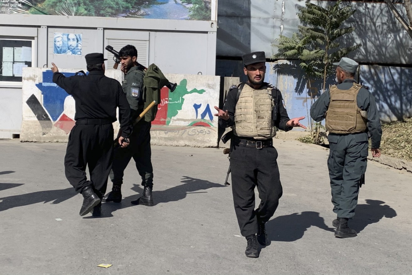 Afghan police arrive at the site of an attack at Kabul University on Monday.