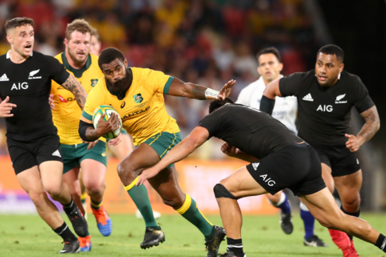 Marika Koroibete powers through the All Blacks' defence in a bone-jarring contest.