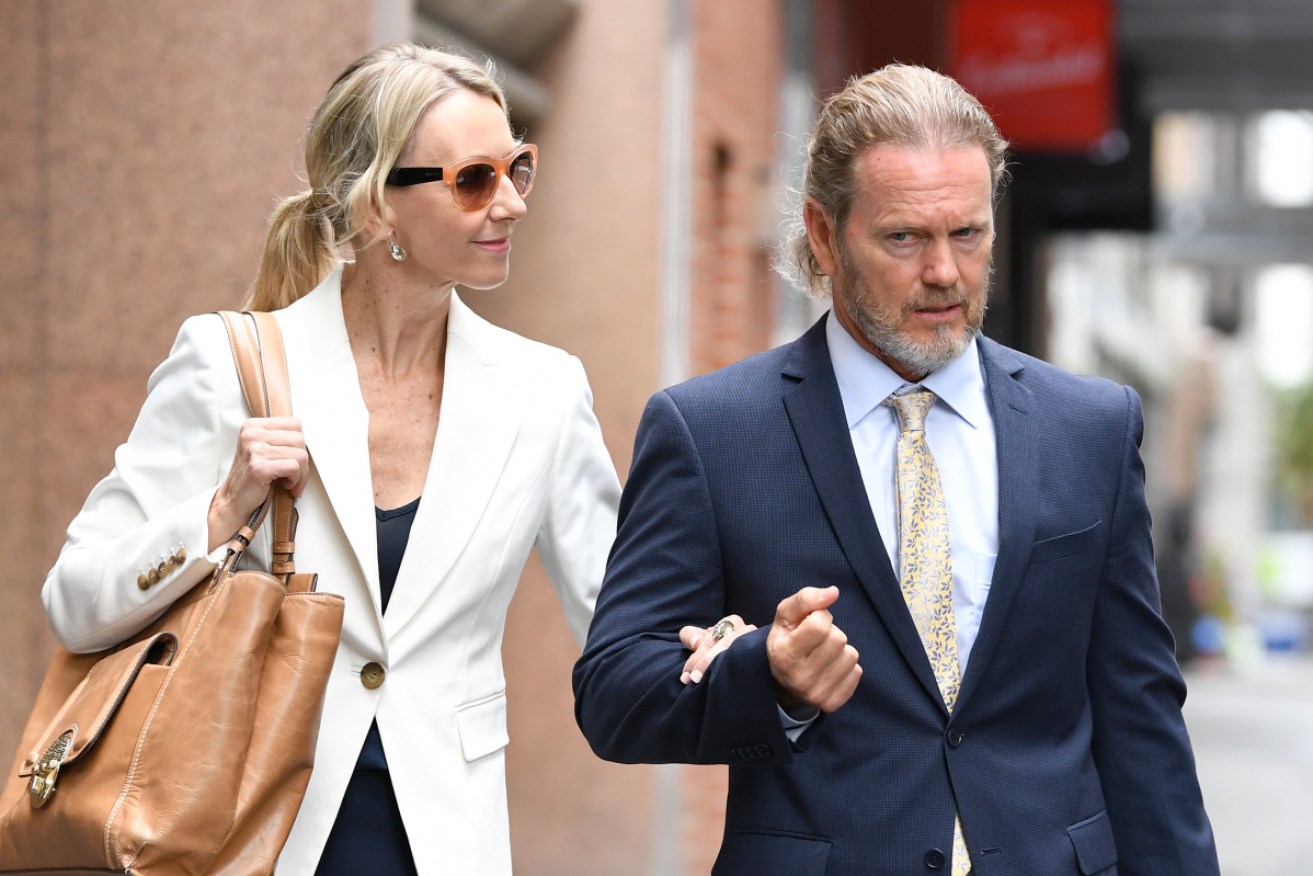 Craig McLachlan and his partner Vanessa Scammell arrive at his lawyer's office in Sydney on Friday.