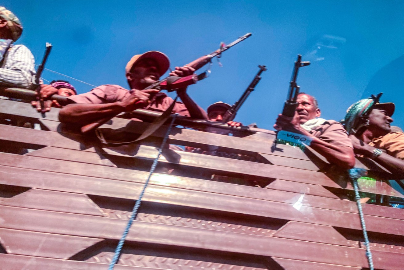 A picture taken through a car window shows Ethiopian Amhara militia fighters.