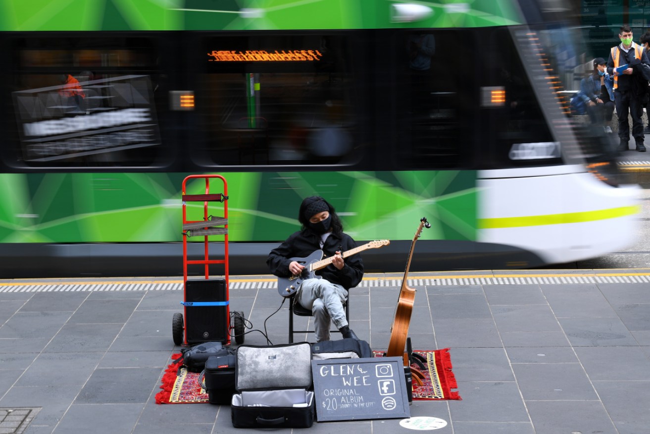 A busker in Melbourne's Bourke Street Mall, which is slowly returning to normal.
