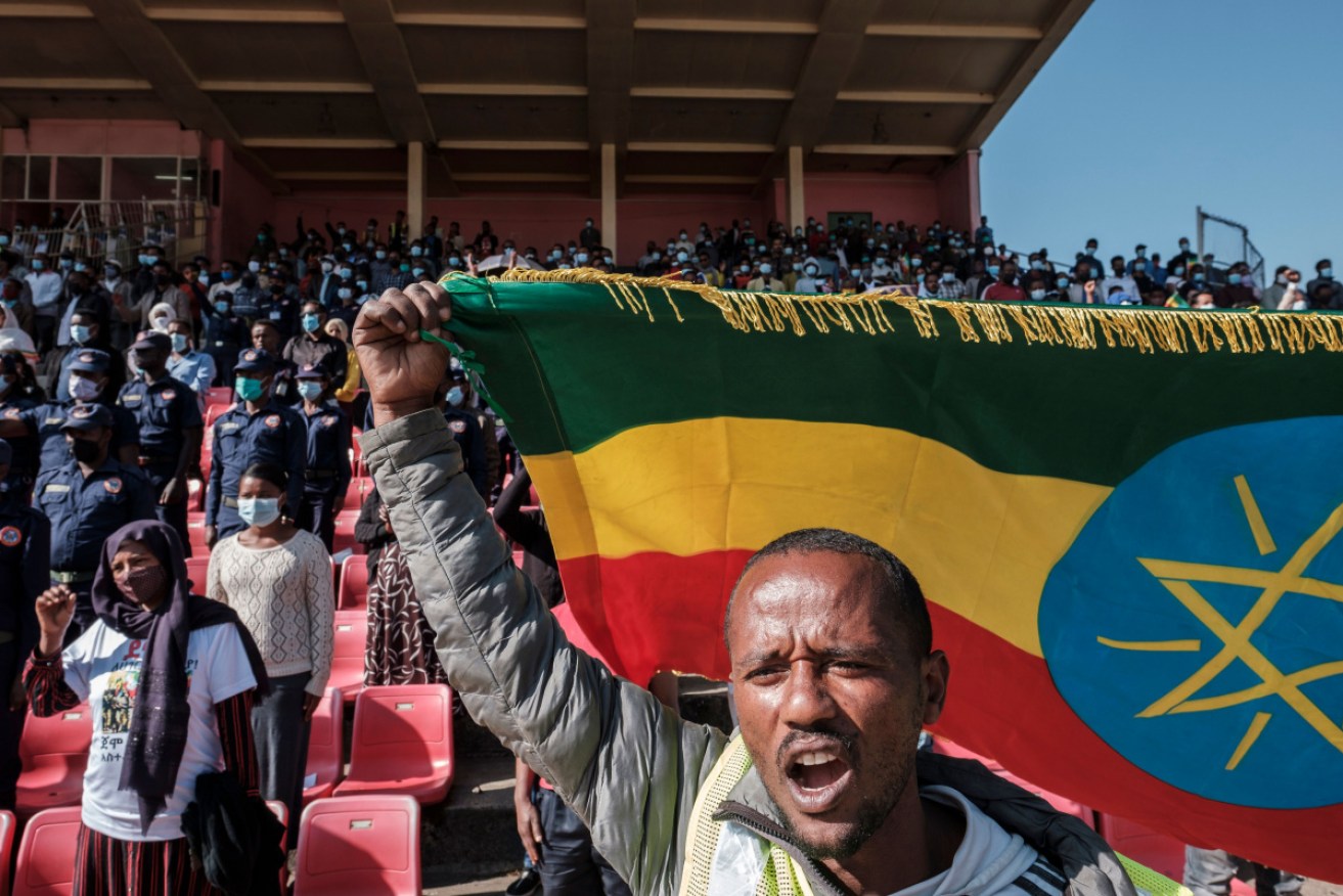 An Ethiopian man waves a flag in support of the government's efforts in Tigray.