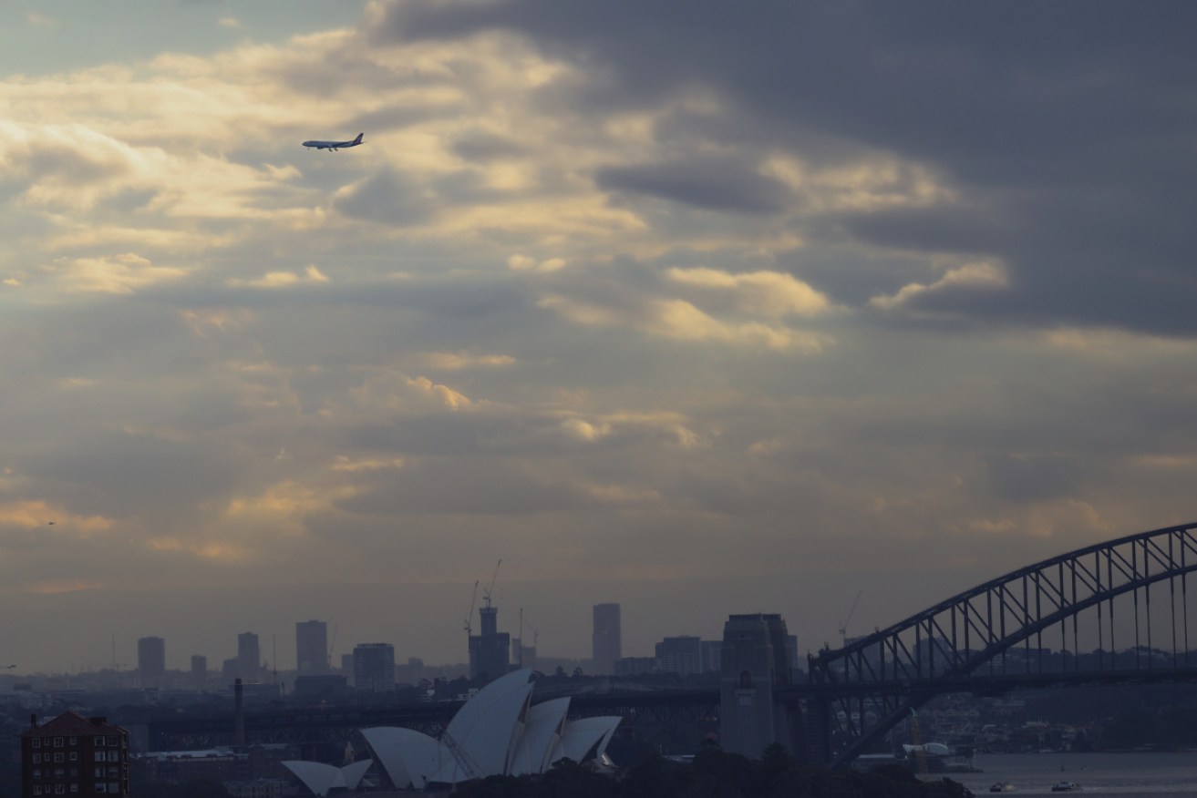 Qantas will celebrate its centenary with a low-level flight over Sydney Harbour on Monday as the pandemic keeps most of its planes on the ground.