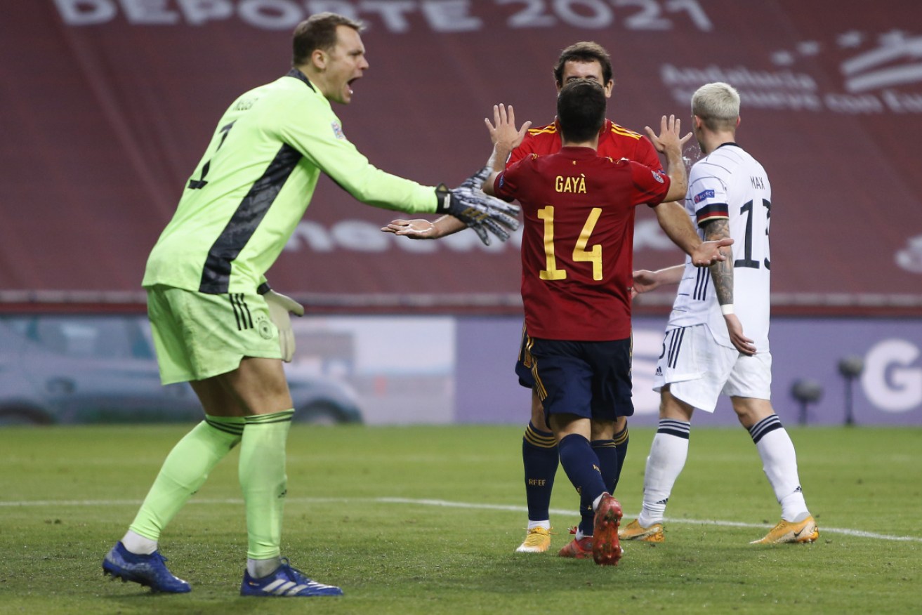 Goalkeeper Manuel Neuer of Germany reacts as Mikel Oyarzabal (back) of Spain celebrates his team's sixth goal with teammate Jose Gaya.