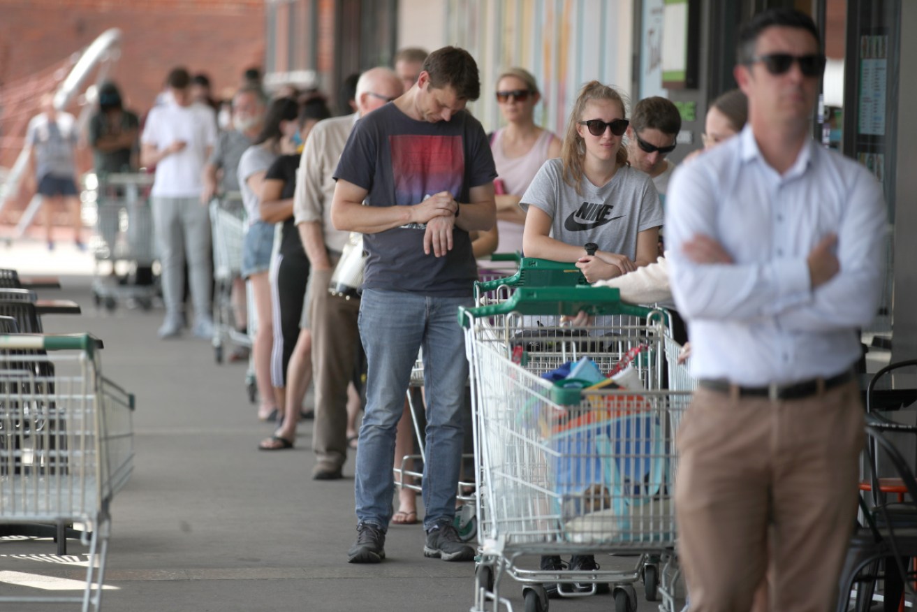 Customers queue at a Woolworths in West Torrens, just hours before the SA shutdown begins.