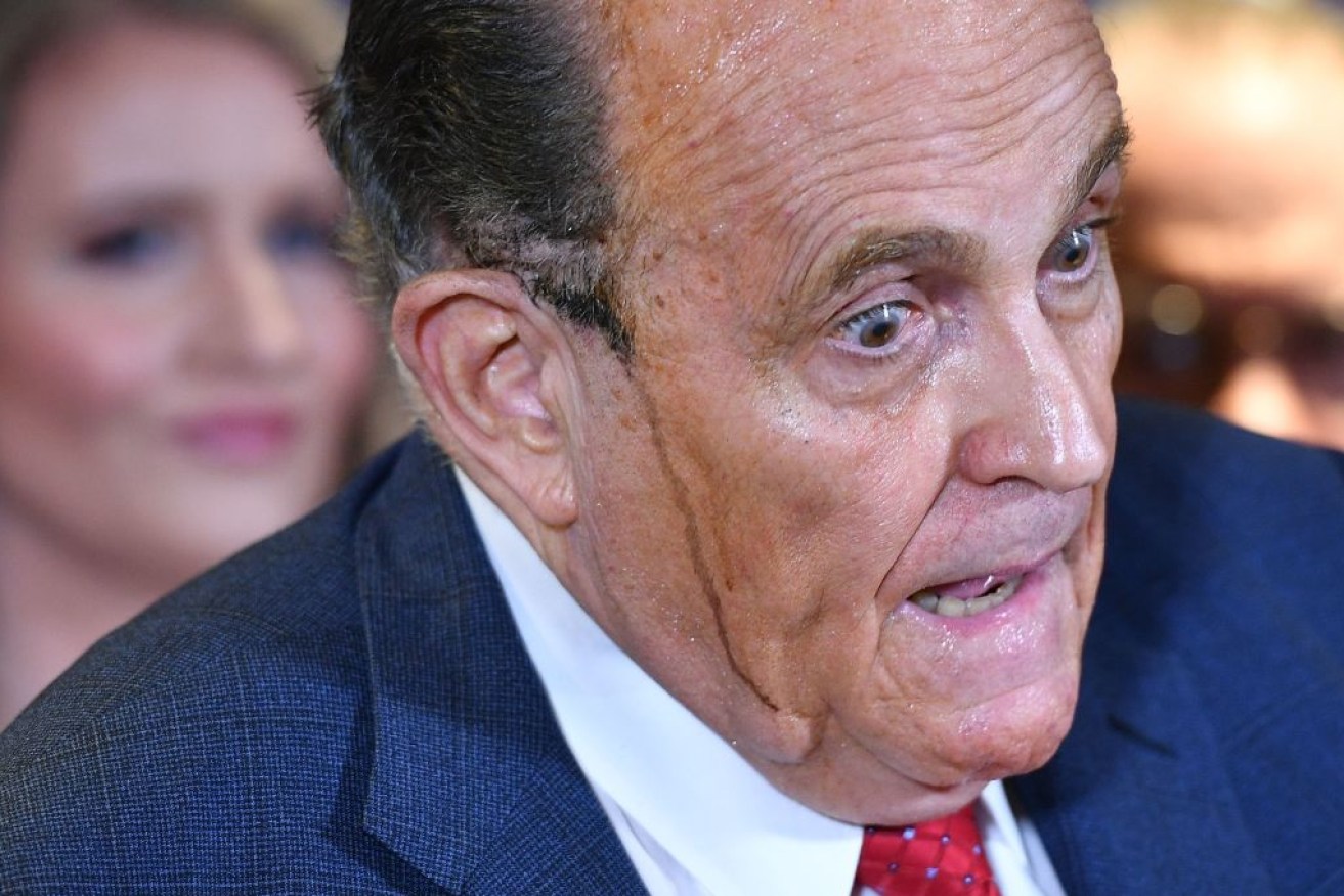 Rudy Giuliani sweats his way through the bizzare press conference. Photo: Getty

