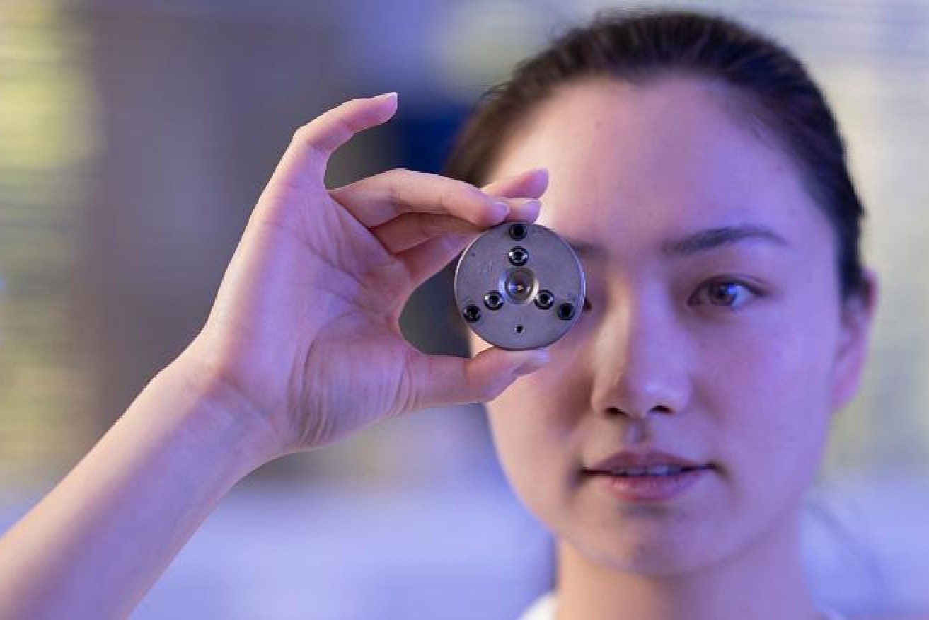 PhD candidate Huang from the Research School of Physics at the ANU with the heat-free diamond anvil.