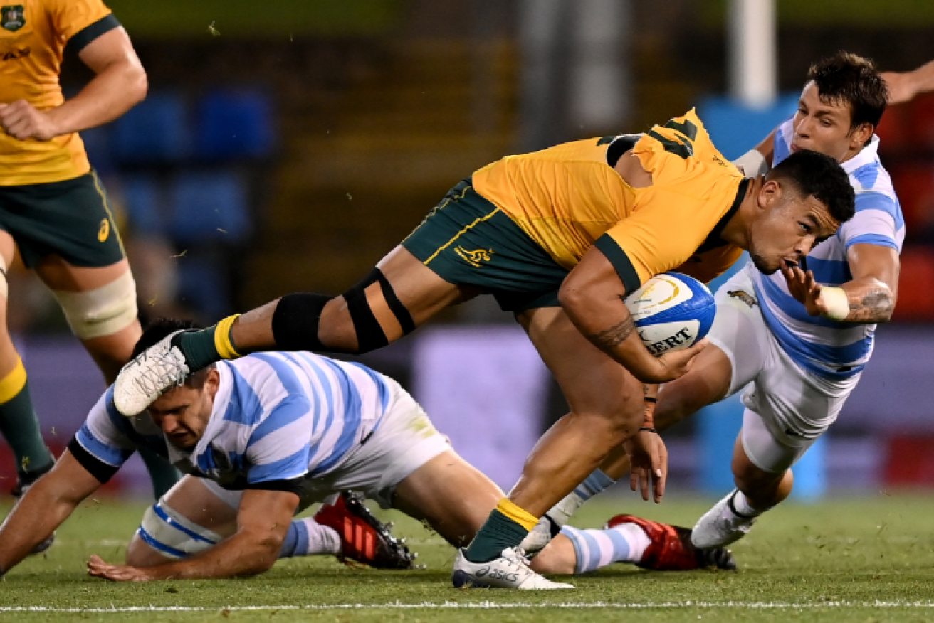 Hunter Paisami of the Wallabies evades a tackle during the Tri Nations rugby match between the Argentina Pumas and Australian Wallabies in Newcastle.