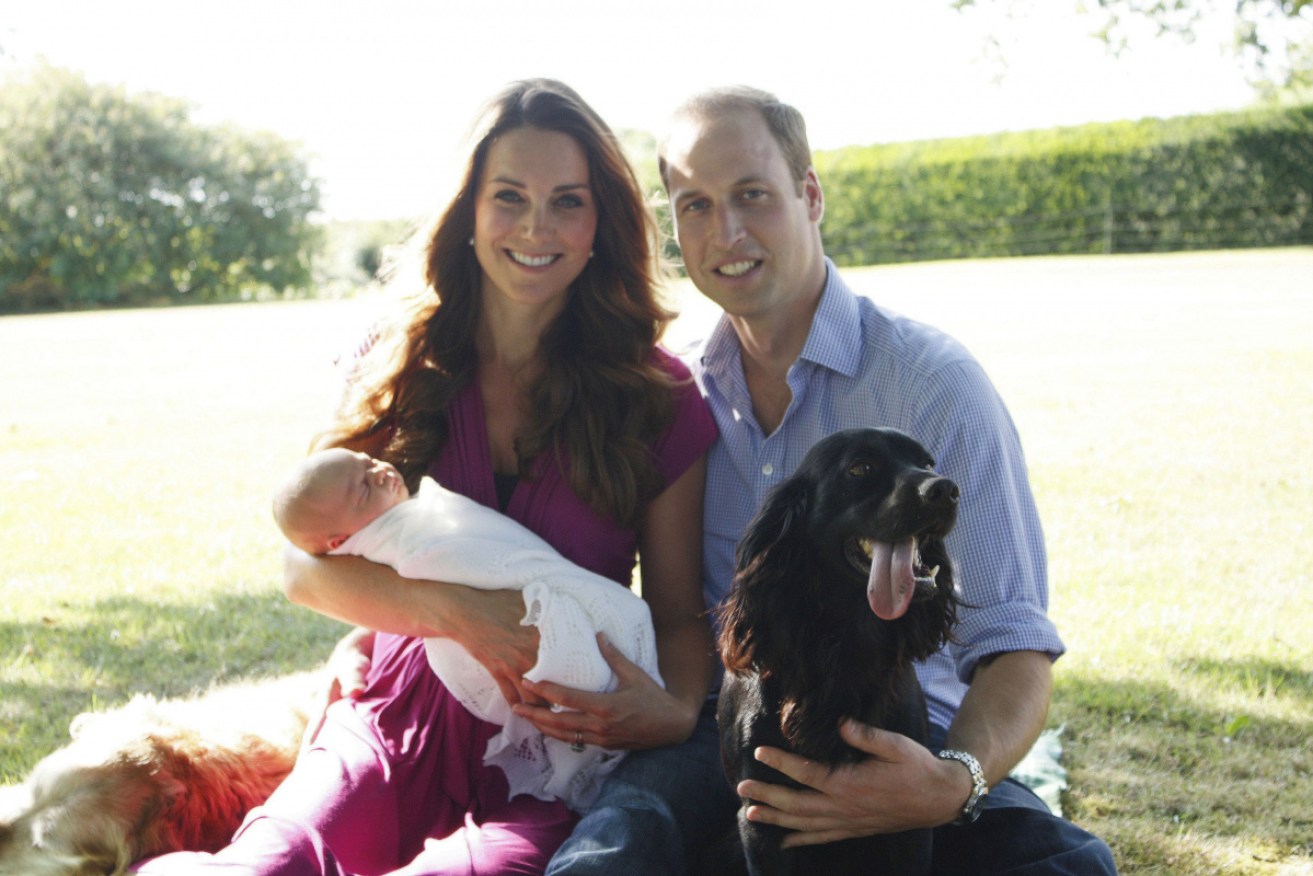 Kate and William with a newborn Prince George and Lupo in the garden of her family home in 2013.