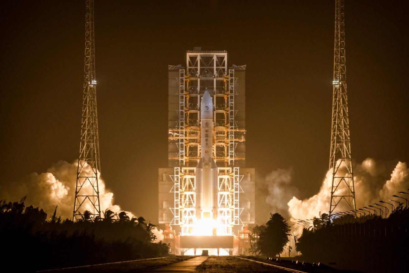 The Long March-5 blasts off in the predawn on Tuesday.