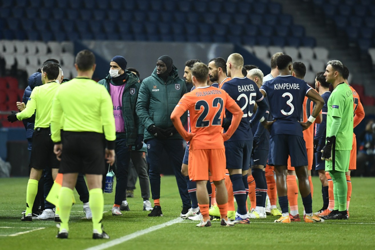 Basaksehir and PSG players congregate after racist language was allegedly used by the fourth official.