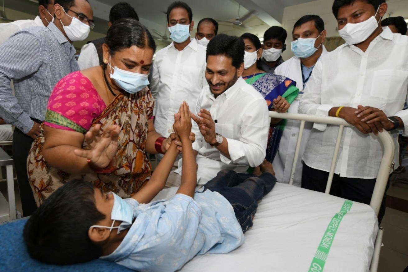 Andhra Pradesh Chief Minister Y.S. Jagan Mohan Reddy (centre) with a patient being treated in hospital.