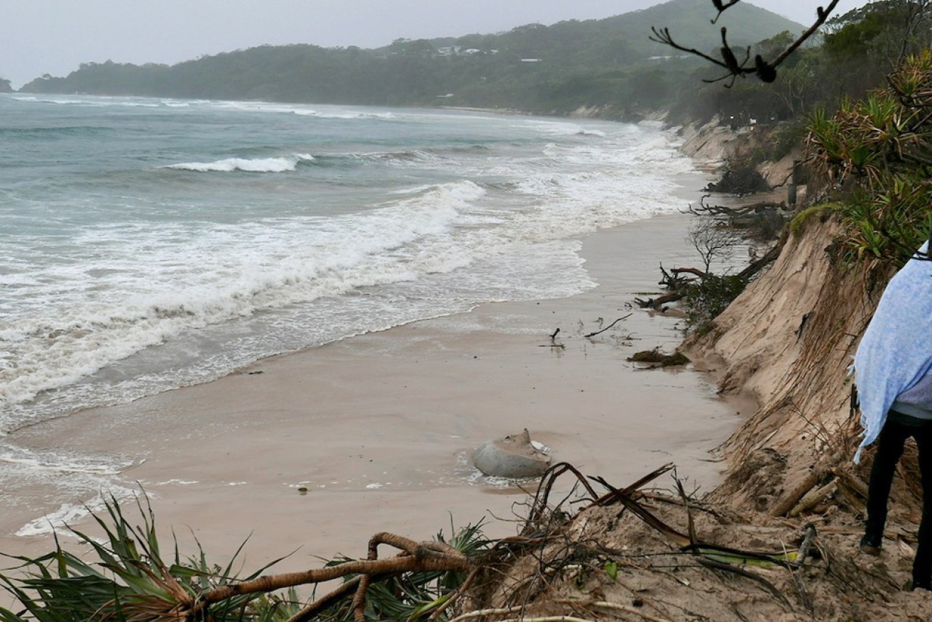 The storm has already all but washed away the beach at Byron Bay.