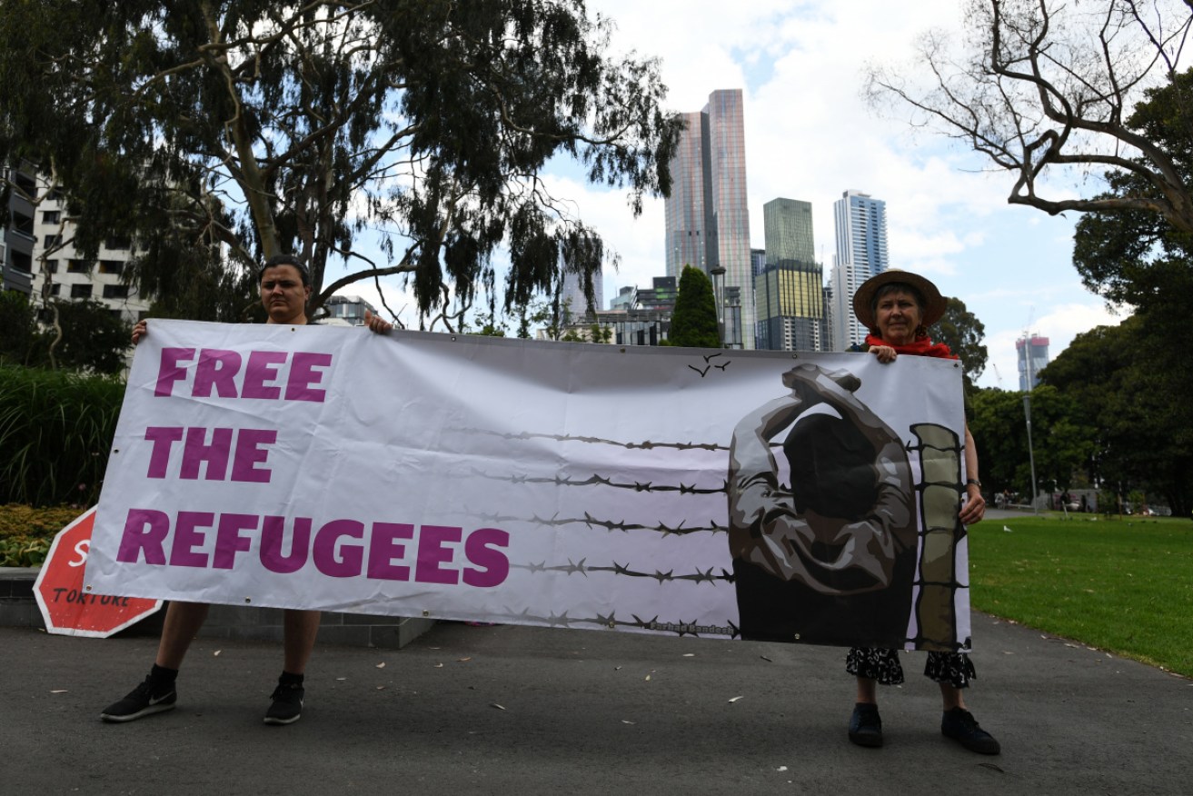 Refugee advocates protest during the police operation.    