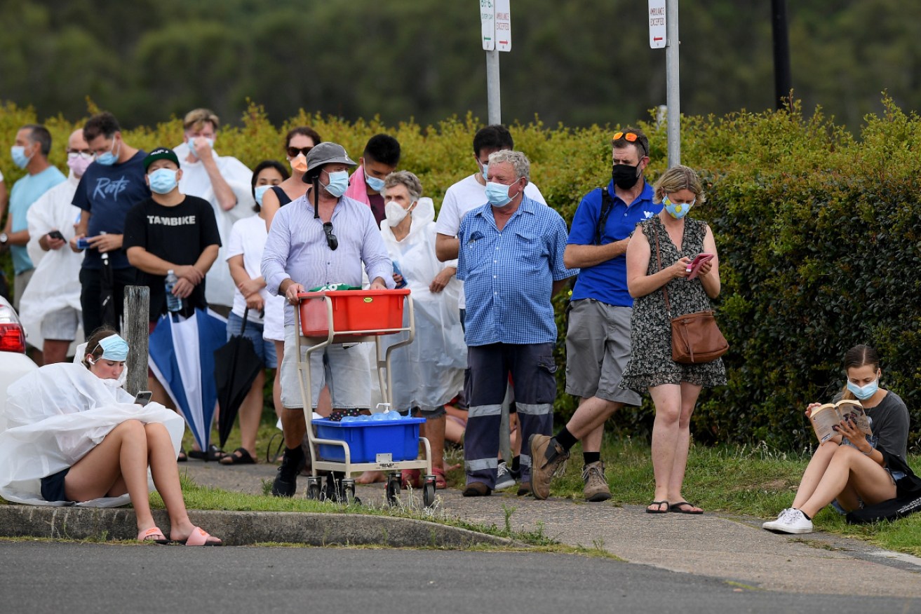 People wait in line for a COVID-19 test at Mona Vale Hospital.