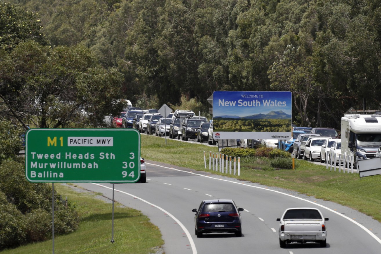 Vehicles queue at the NSW-Queensland border on Monday. Photo: Getty