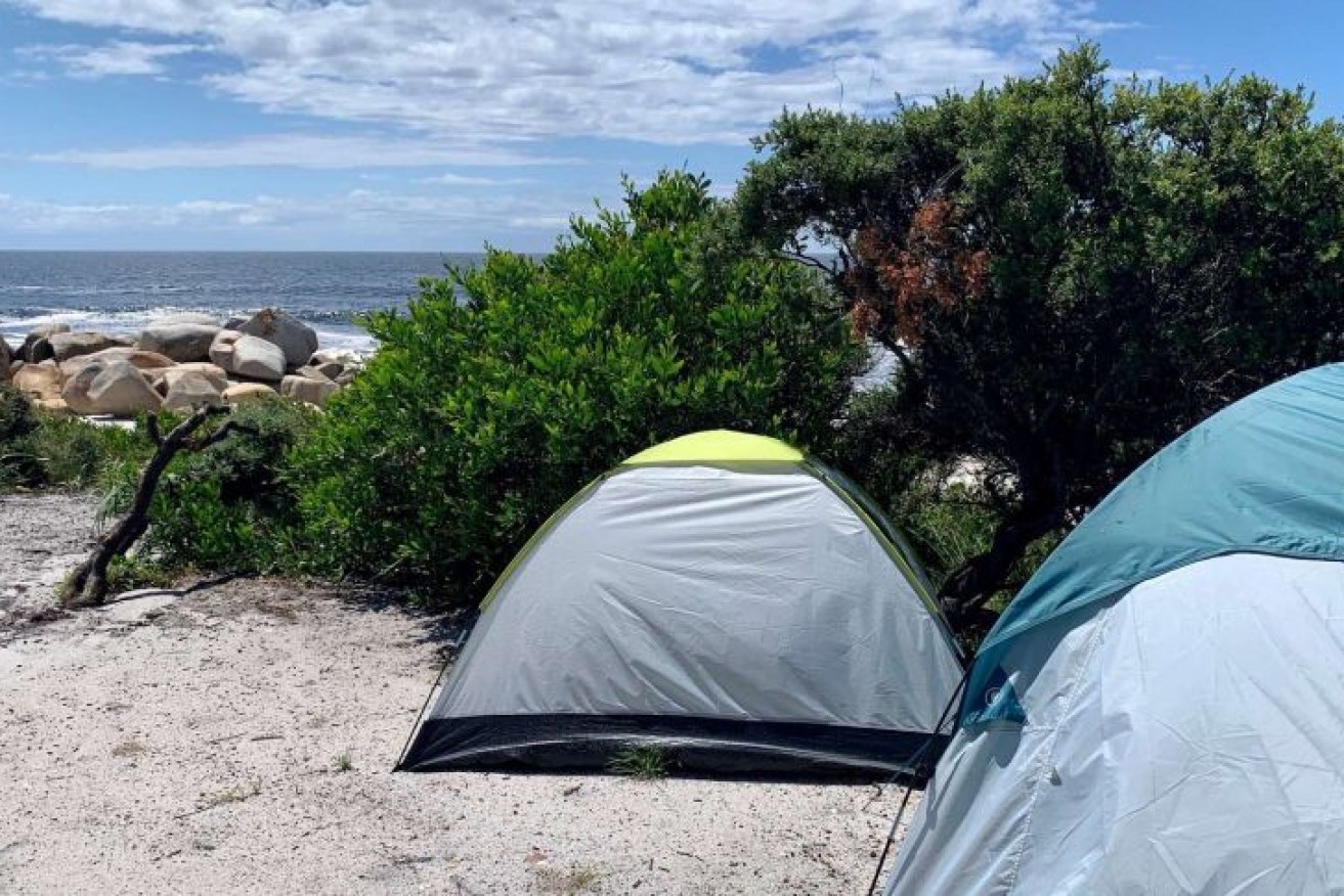 Tasmania's Bay of Fires is a popular camping destination for tourists and locals. 