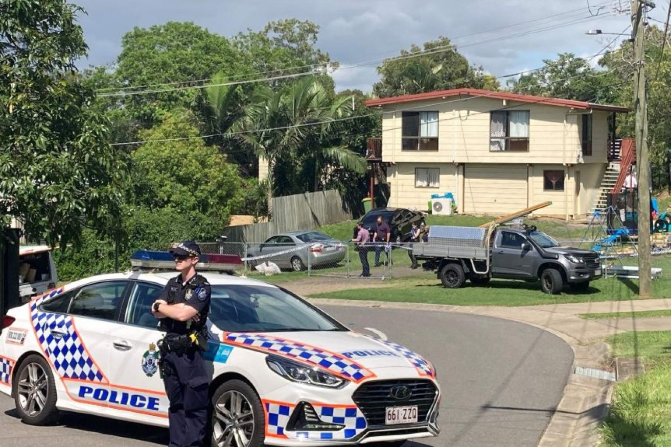 Police at the house in North Ipswich where a man was fatally stabbed.