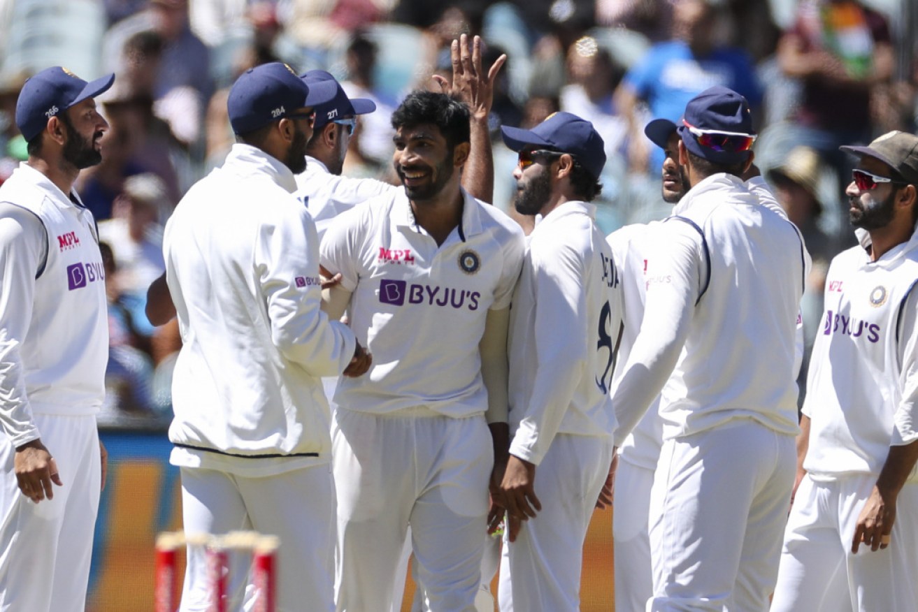 The Indian players celebrate at the MCG. 