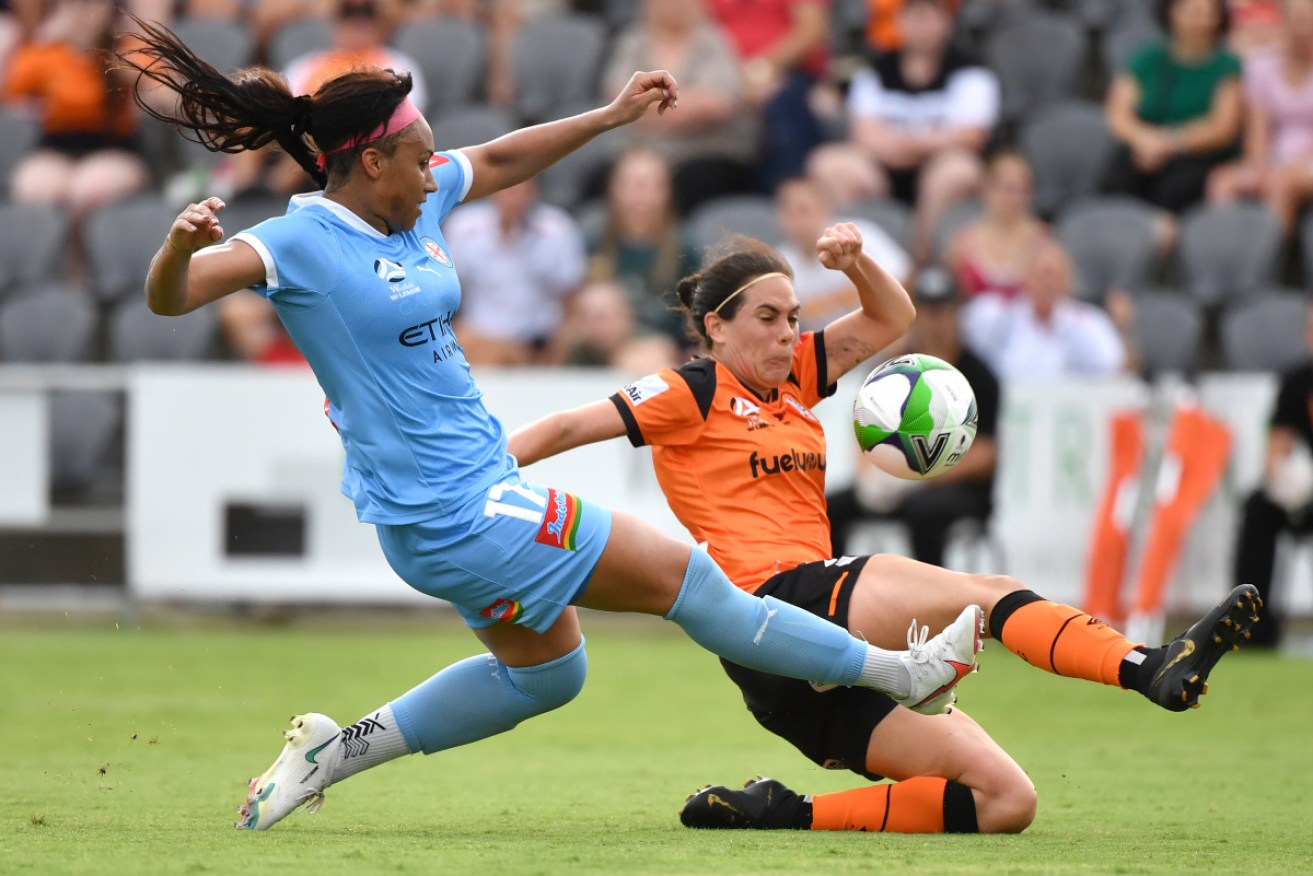 Melbourne City's Sam Johnson tackles Brisbane’s Rosie Sutton in the W-League at Dolphin Stadium on Tuesday.