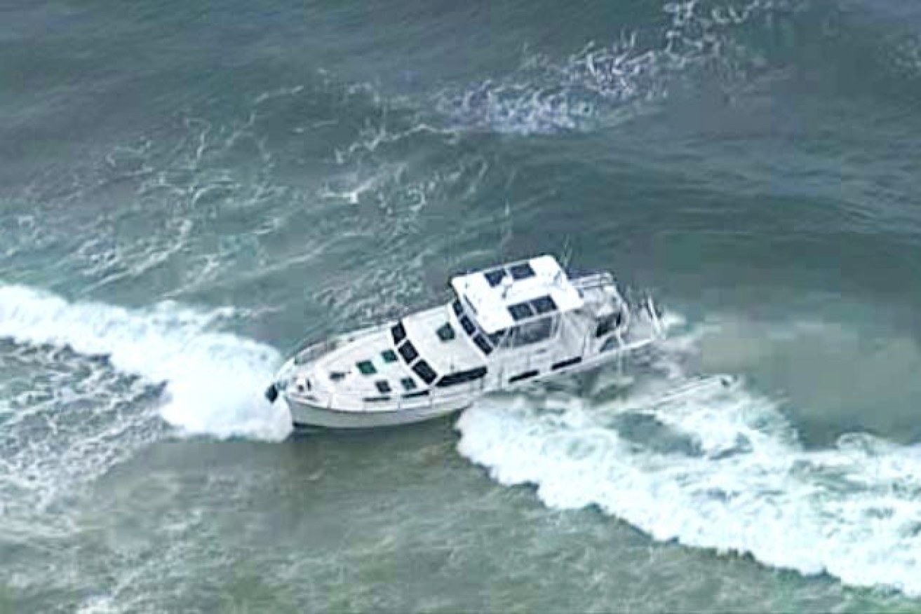 The boat ran aground with a dog on board in waters off the Sunshine Coast after a man fell overboard.