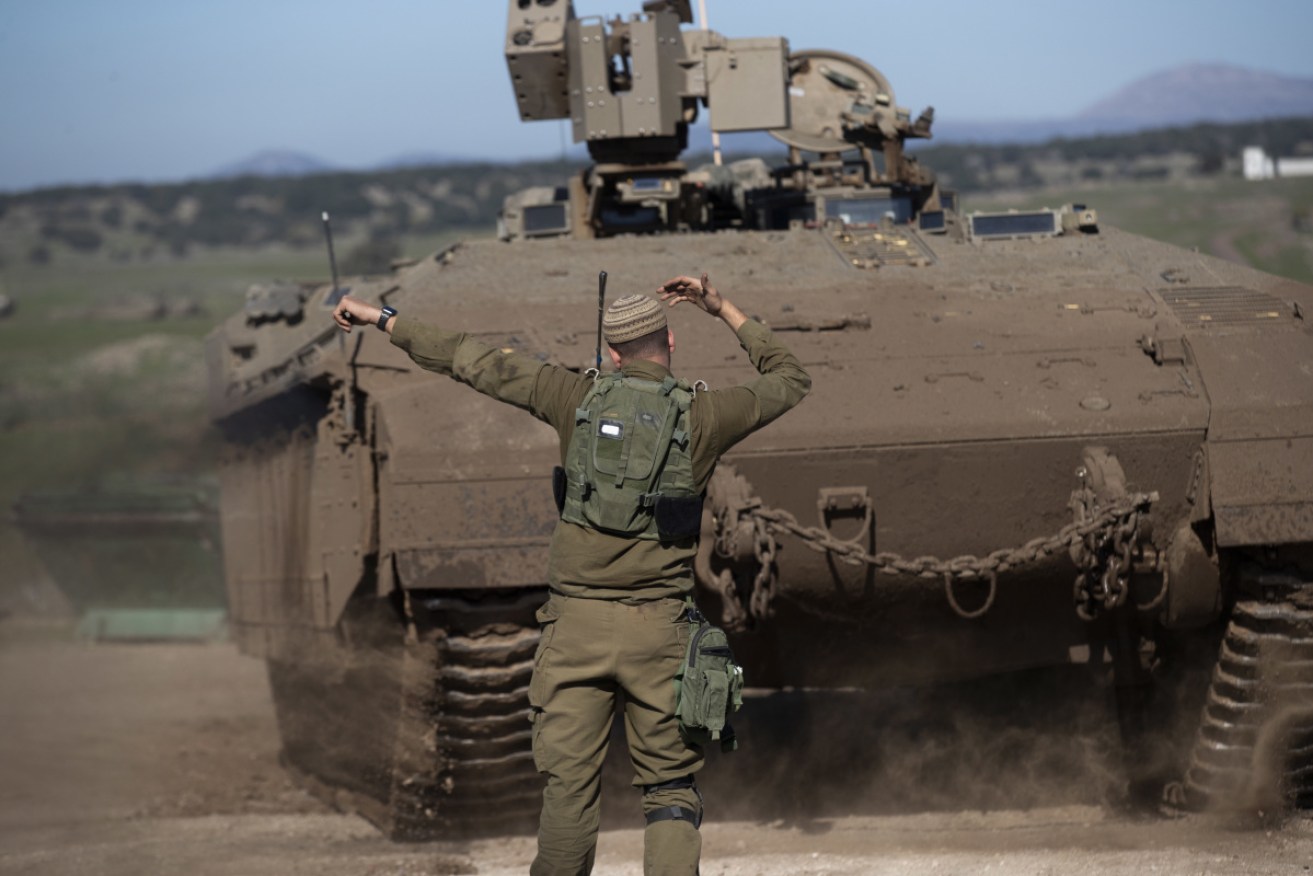 Israeli soldiers direct armoured personnel carriers at Golan Heights, near the Syrian border, on Wednesday.