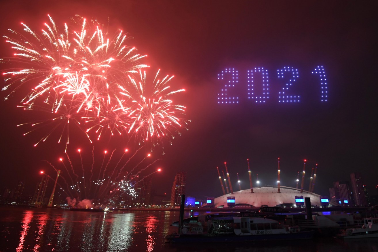 Fireworks and drones illuminate the night sky over the The O2 in London as they form a light display as London's normal New Year's Eve fireworks display was cancelled due to the coronavirus pandemic.