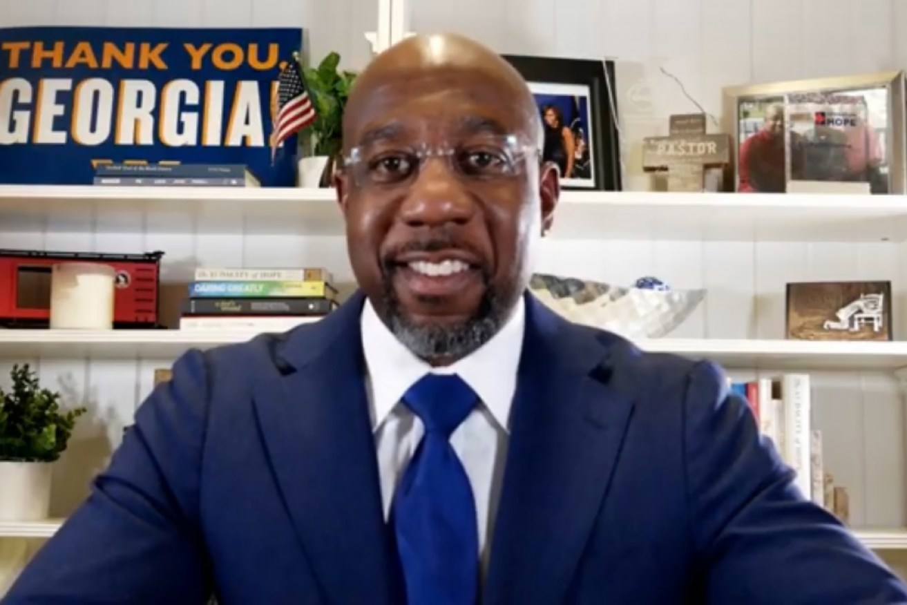 Reverend Raphael Warnock speaks via his YouTube channel after midnight in Atlanta, Georgia on Wednesday. 