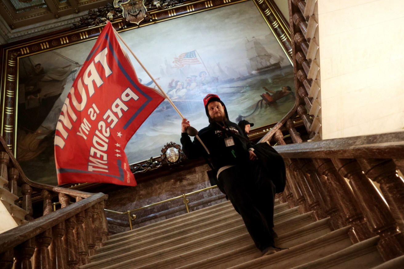 A protester holds a Trump flag inside the US Capitol Building during the riot. 