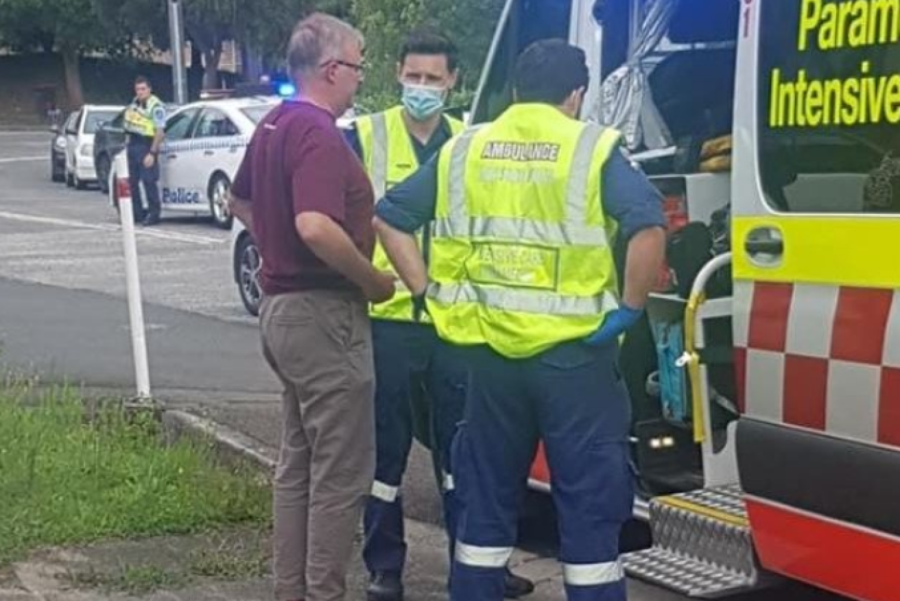 Paramedics at the crash scene ready Anthony Albanese for the short trip to hospital.