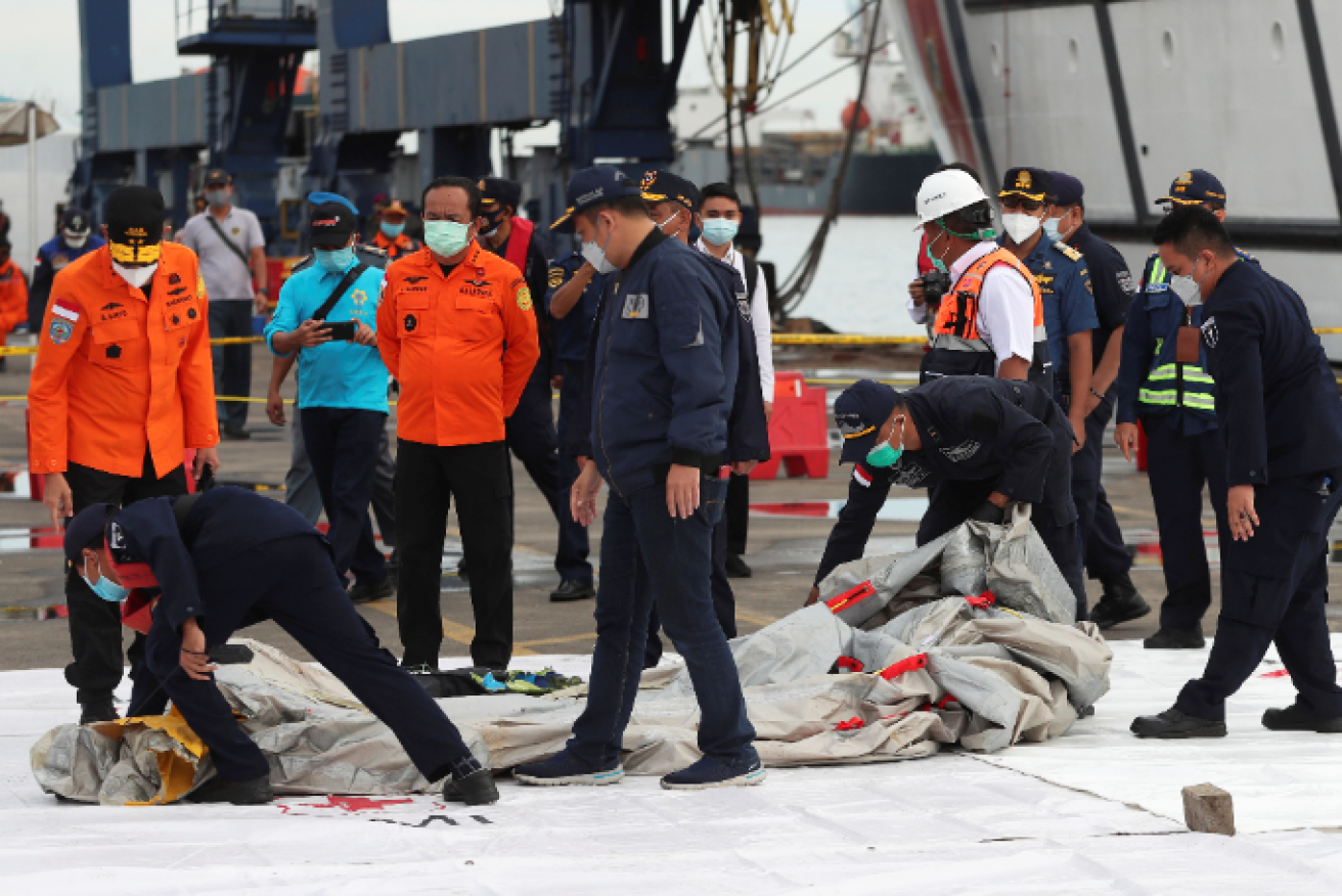 An Indonesian disaster response teams readies retrieval equipment before heading the crash site.