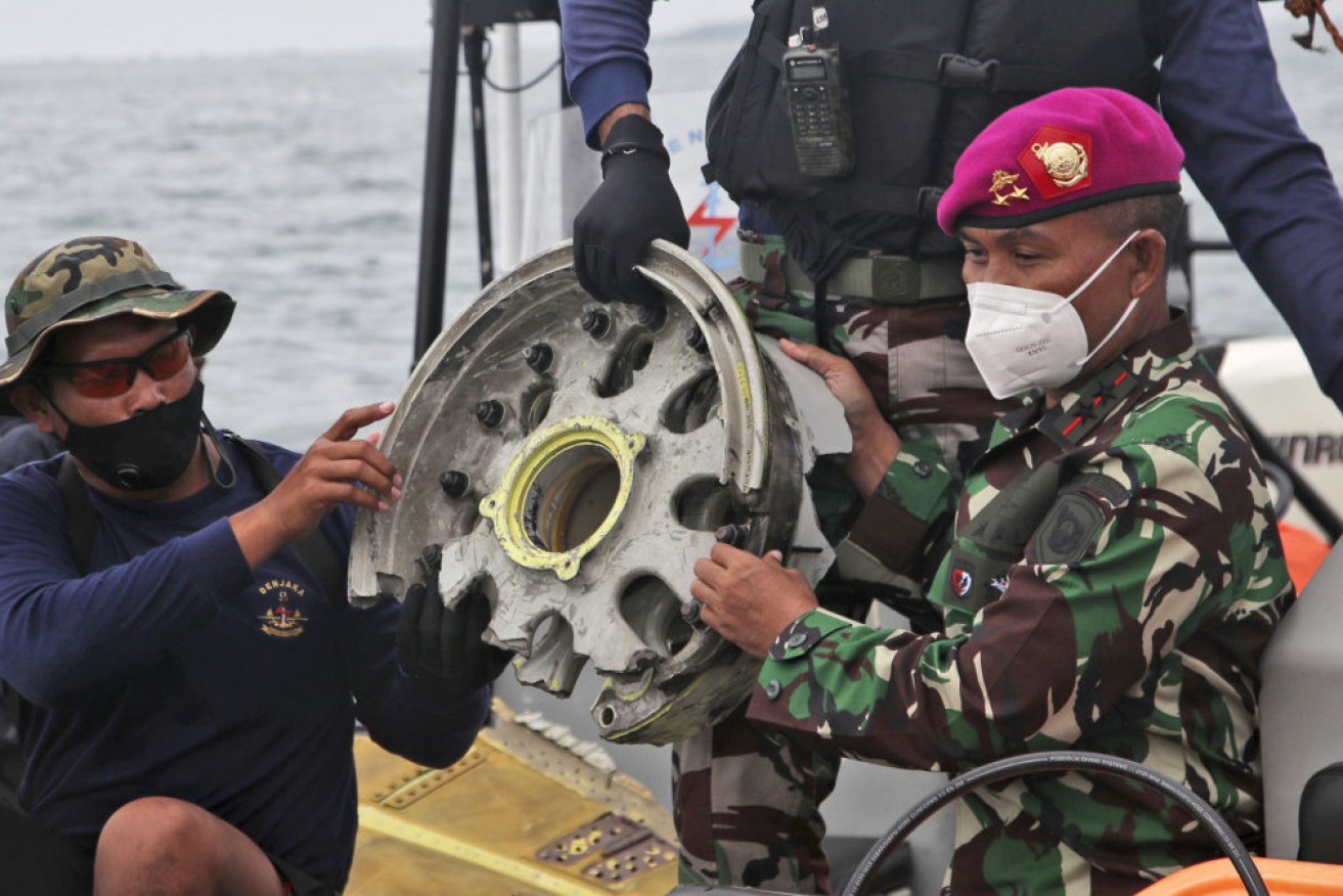 Indonesian Navy divers recover parts of the Sriwijaya Air jet after it crashed into the sea near Jakarta.