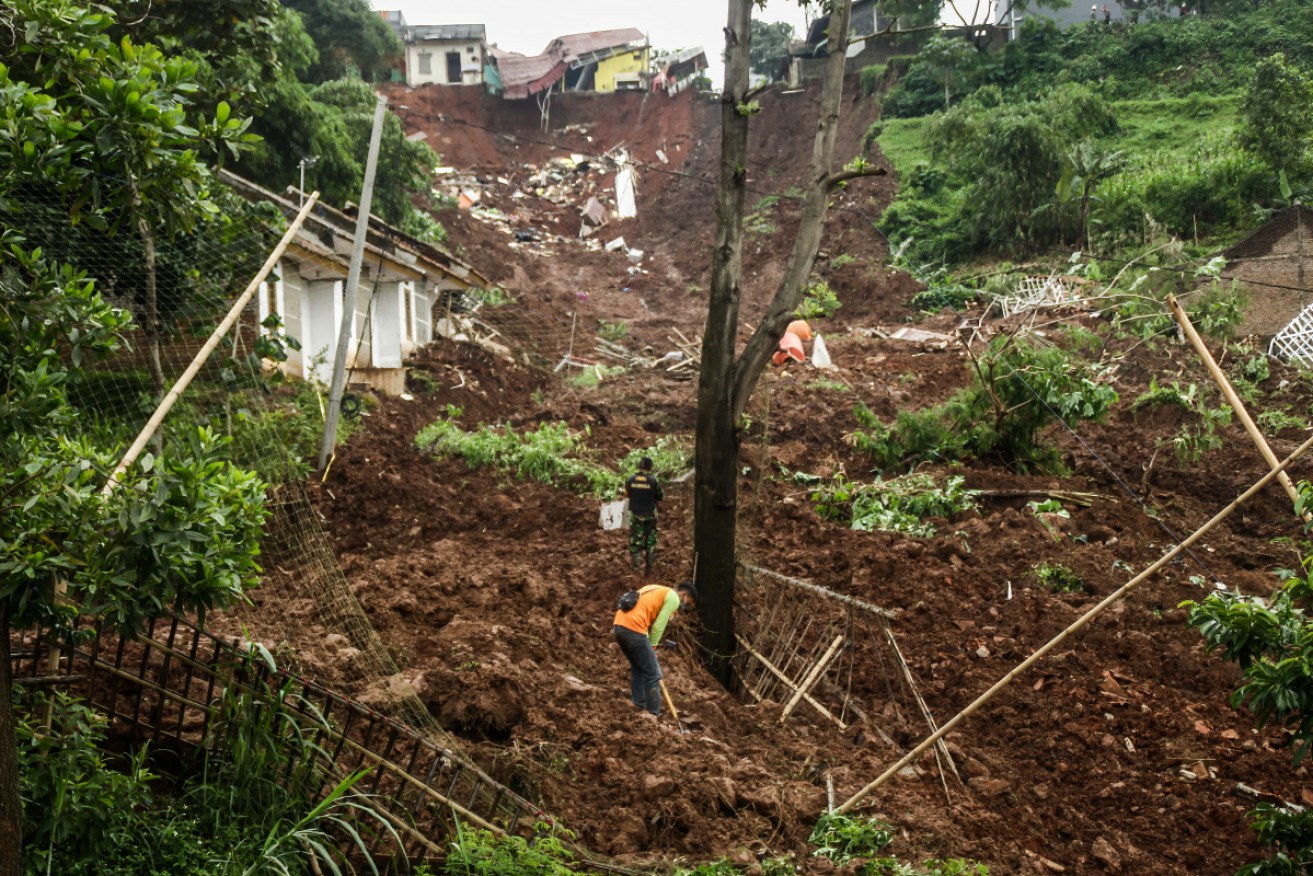 Rescue team seen looking for victims who were buried down by the landslides in Cihanjuang Village. 