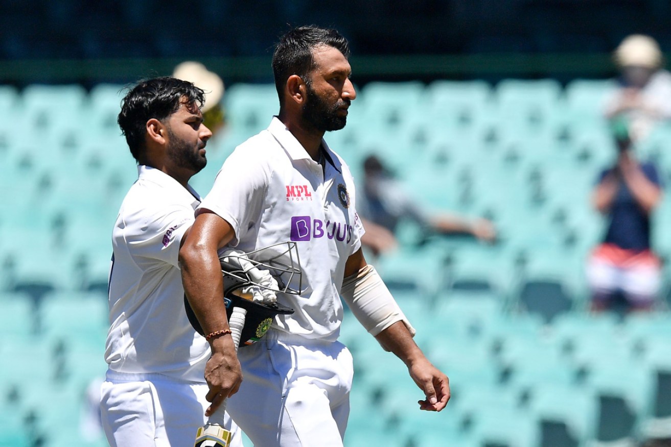 Indian batsmen Cheteshwar Pujara (R) and Rishabh Pant walk off the field at the lunch break during day five of the third cricket Test.