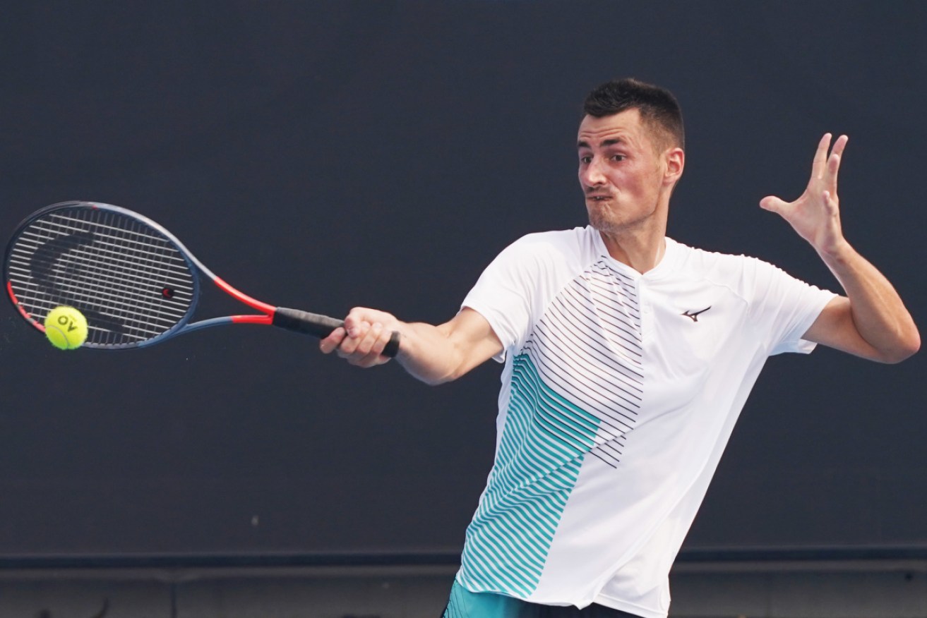 Bernard Tomic took the first step towards redemption with his qualifying win in Doha on Monday.
