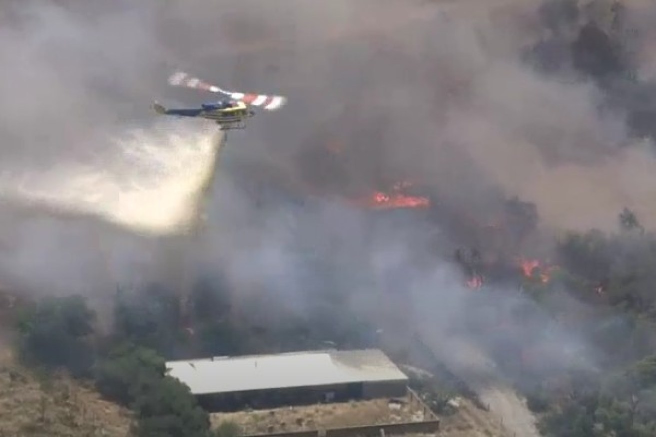 A bushfire encroaches on homes in Perth.