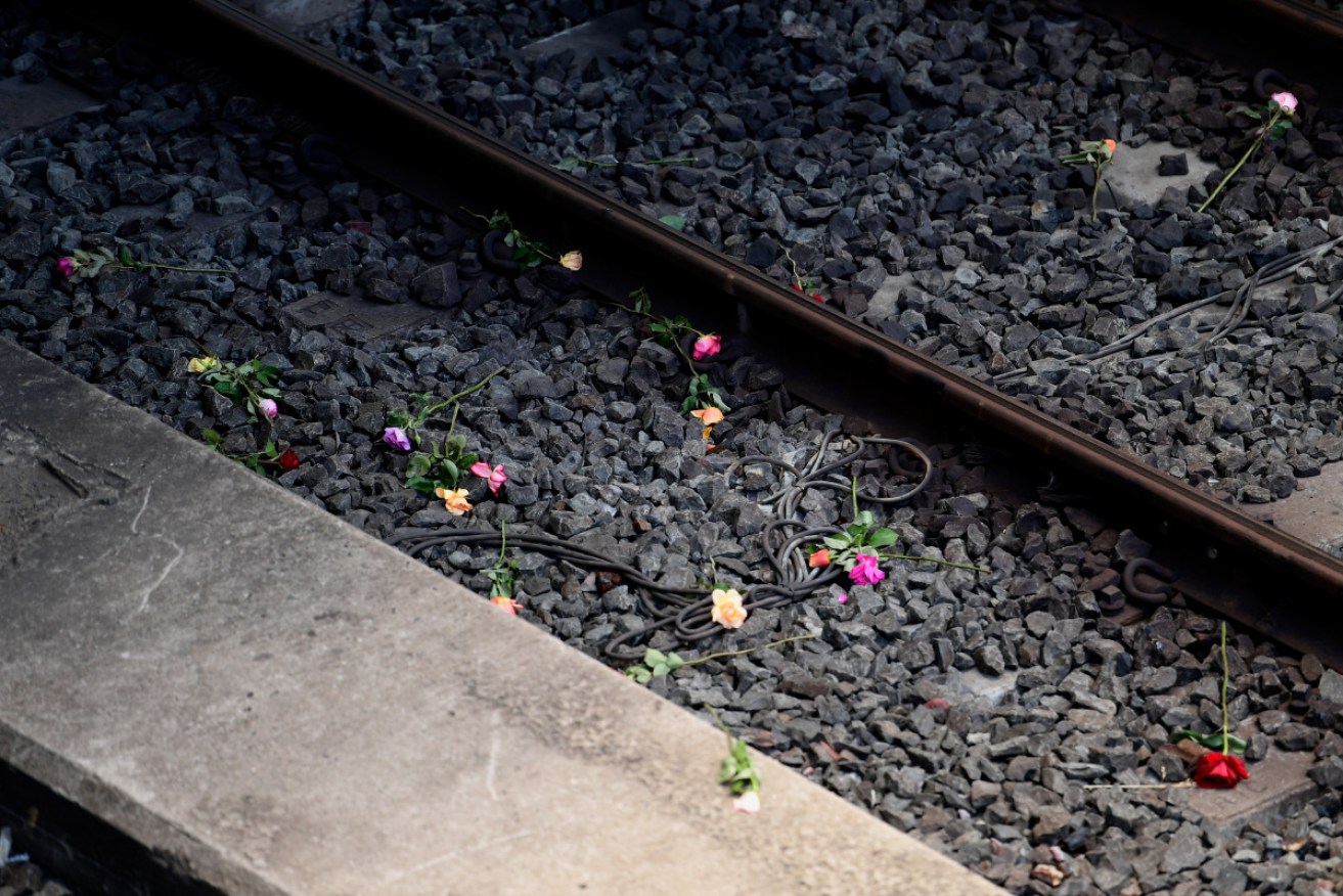 Roses lay on the tracks during the 40th anniversary of the Granville train disaster in 2017 in Sydney.