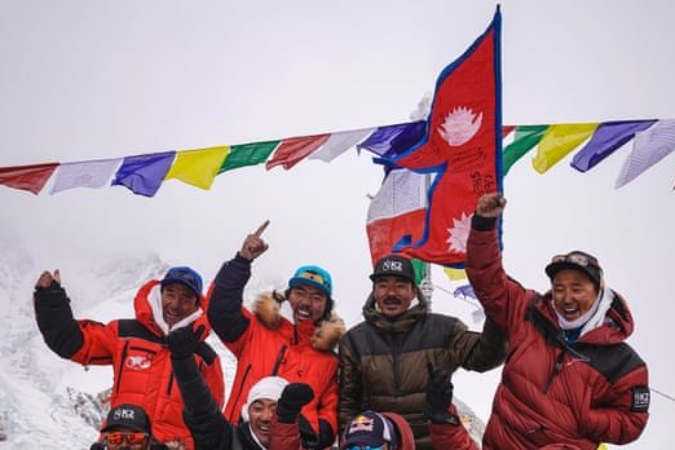 Nimsdai Purja and his team celebrate reaching the summit of K2. 