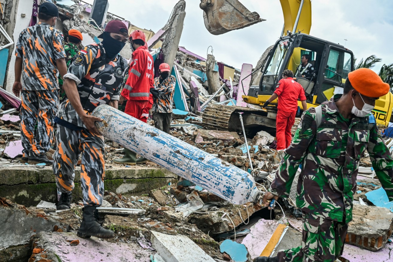 Soldiers clear debris while looking for victims at Mamuju after the 6.2 magnitude earthquake. 