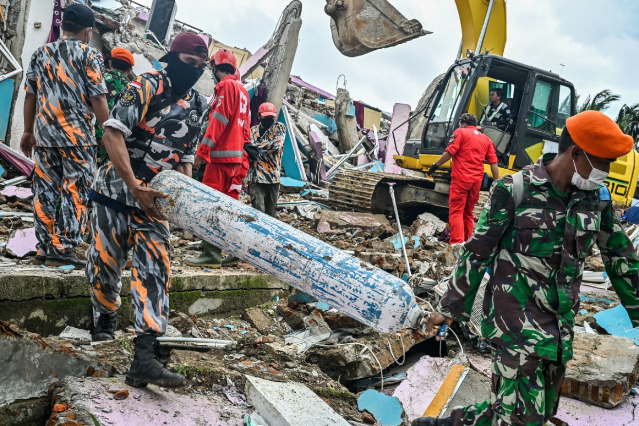 Soldiers clear debris while looking for victims at Mamuju after the 6.2 magnitude earthquake.
