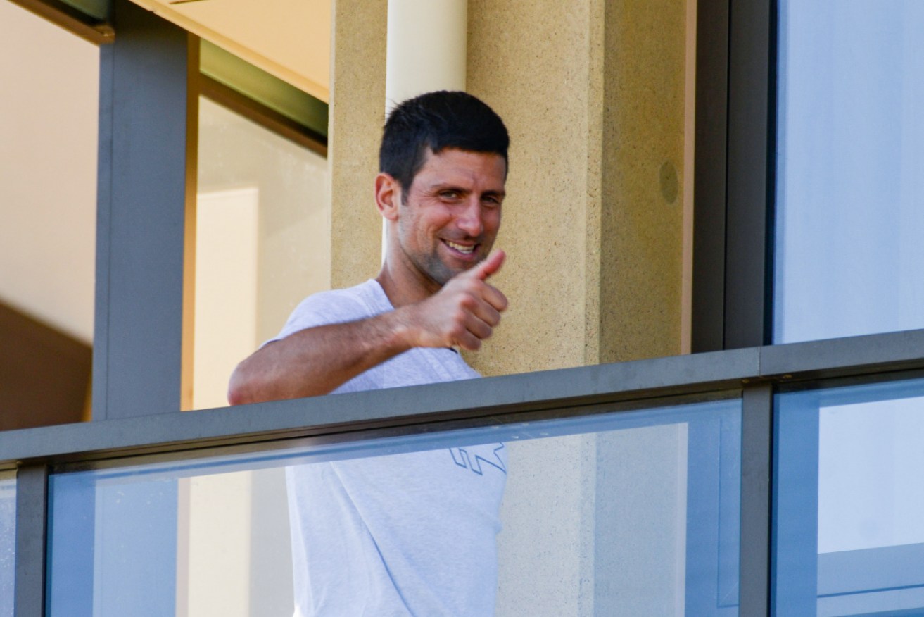 Novak Djokovic of Serbia gestures from his hotel balcony in Adelaide on Monday. 